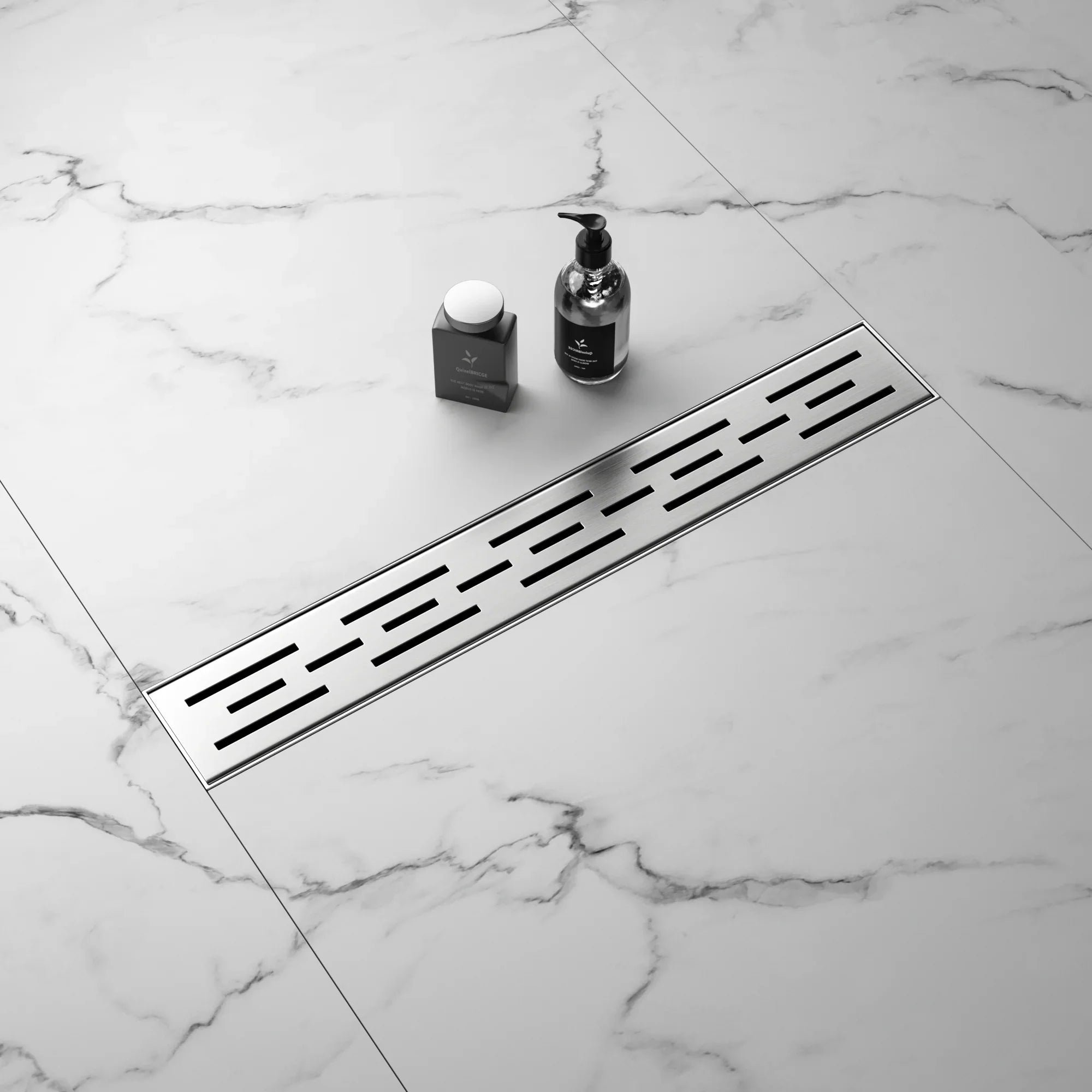 Stainless steel linear shower drain on marble tile bathroom floor with soap and dispenser.